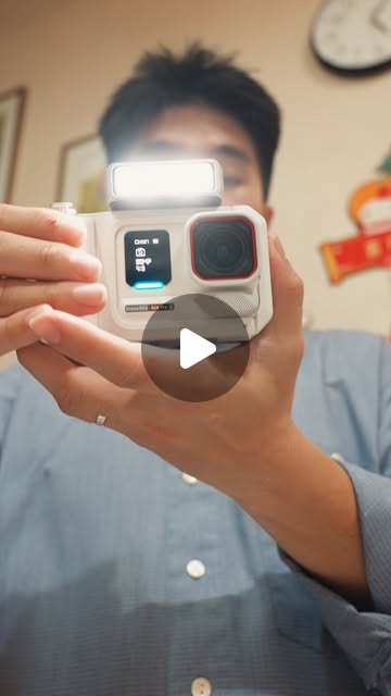 Jing Xian holding the Insta360 Pocket Printer towards the camera.