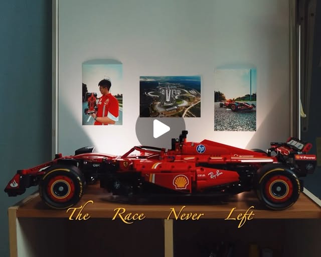 A red LEGO Formula 1 car displayed in front of racing photographs.